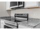 Close-up of the kitchen with stainless steel appliances and granite countertops at 8983 Wade St, Brooksville, FL 34613