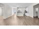 Open-concept living room with lots of natural light, white walls, and wood-look floors at 8983 Wade St, Brooksville, FL 34613