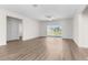 Spacious living room with wood-look floors and a large sliding glass door leading to the backyard at 8983 Wade St, Brooksville, FL 34613
