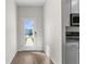 Mudroom with wood-look flooring, white walls and trim, and a view of the outside at 8983 Wade St, Brooksville, FL 34613