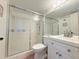 Clean bathroom featuring a glass enclosed shower, white vanity, and neutral accents at 9000 Commodore Dr # 302, Seminole, FL 33776