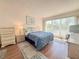 Bright bedroom features a large window, comfortable bedding, and neutral decor at 9000 Commodore Dr # 302, Seminole, FL 33776