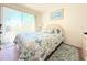 Bright bedroom with a relaxing bed, large window, and calming color palette at 9000 Commodore Dr # 302, Seminole, FL 33776