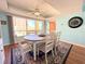 Sunny dining area with a round table, seating for six, and bright natural light at 9000 Commodore Dr # 302, Seminole, FL 33776