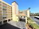 Condo complex with lovely landscaping, covered parking, and a welcoming entrance at 9000 Commodore Dr # 302, Seminole, FL 33776