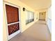 Hallway leading to unit with outdoor lighting and windows at 9000 Commodore Dr # 302, Seminole, FL 33776