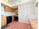 Kitchen featuring wood cabinets, linoleum flooring, a closet and appliances at 9000 Commodore Dr # 302, Seminole, FL 33776