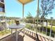 Screened lanai with a table, offering a view of the surrounding community and lush greenery at 9000 Commodore Dr # 302, Seminole, FL 33776