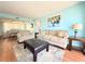 Bright living room features a cozy seating area and adjacent dining space at 9000 Commodore Dr # 302, Seminole, FL 33776