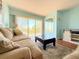 Living room with sliding doors that lead to the lanai and offer scenic views at 9000 Commodore Dr # 302, Seminole, FL 33776