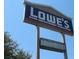 A clear, bright Lowe's sign against a blue sky, surrounded by lush greenery at 9035 Prosperity Ln, Port Richey, FL 34668