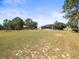Expansive backyard with lawn, leading to the screened lanai of the house at 10188 Whisper Ridge Trail Trl, Weeki Wachee, FL 34613
