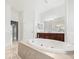 Bathroom featuring a large soaking tub, tile flooring, and dark wood vanity at 10188 Whisper Ridge Trail Trl, Weeki Wachee, FL 34613
