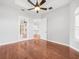Spacious bedroom with hardwood floors, ceiling fan, and ample closet space at 10188 Whisper Ridge Trail Trl, Weeki Wachee, FL 34613