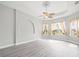 Bright bedroom with hardwood floors, fan, recessed lighting, and natural light from large windows at 10188 Whisper Ridge Trail Trl, Weeki Wachee, FL 34613
