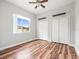 This bedroom has hardwood floors, ceiling fan, and large window for plenty of natural light at 10188 Whisper Ridge Trail Trl, Weeki Wachee, FL 34613