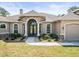 Close up of the front entrance, showcasing a stone archway and double doors at 10188 Whisper Ridge Trail Trl, Weeki Wachee, FL 34613