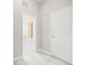 Bright hallway with tile floors and view into the laundry room at 10188 Whisper Ridge Trail Trl, Weeki Wachee, FL 34613