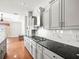 Kitchen with modern appliances, granite countertops, white cabinets, and hardwood floors at 10188 Whisper Ridge Trail Trl, Weeki Wachee, FL 34613