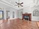 Well-lit living room features hardwood floors, a fireplace, and an open layout at 10188 Whisper Ridge Trail Trl, Weeki Wachee, FL 34613