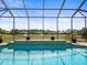 Screened-in pool offers views of the green backyard and surrounding neighborhood at 10188 Whisper Ridge Trail Trl, Weeki Wachee, FL 34613