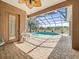 Screened-in pool overlooking a vast green space perfect for entertaining at 10188 Whisper Ridge Trail Trl, Weeki Wachee, FL 34613