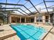 Screened-in pool with brick surround and view of the lanai at 10188 Whisper Ridge Trail Trl, Weeki Wachee, FL 34613