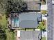 Aerial view of the home with a screened pool, showcasing its layout and location within a residential area at 11700 Leda Ln, New Port Richey, FL 34654