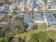 Aerial view of home with a screened pool in a neighborhood setting with mature landscaping at 11700 Leda Ln, New Port Richey, FL 34654