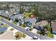 The property in an aerial view, with landscaped front yard, driveway, and well-manicured surroundings at 11700 Leda Ln, New Port Richey, FL 34654