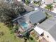 Aerial view of home with a screened-in pool and well-maintained landscaping at 11700 Leda Ln, New Port Richey, FL 34654