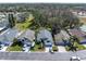 Aerial view of the property nestled among well-maintained homes in a tranquil, tree-lined neighborhood at 11700 Leda Ln, New Port Richey, FL 34654