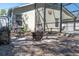 Cozy backyard patio featuring a fire pit and screened-in pool for outdoor relaxation and entertaining at 11700 Leda Ln, New Port Richey, FL 34654
