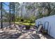 Backyard patio with a fire pit and seating area, framed by a white fence at 11700 Leda Ln, New Port Richey, FL 34654