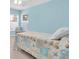 Bedroom featuring blue walls and a single bed with a blue and orange comforter at 11700 Leda Ln, New Port Richey, FL 34654
