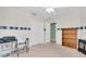 Neutral bedroom with an open door and closet, desk, bookshelf and carpet at 11700 Leda Ln, New Port Richey, FL 34654