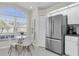 Breakfast nook with lots of light from a large arched window and stainless steel refrigerator at 11700 Leda Ln, New Port Richey, FL 34654