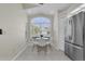 Light and airy breakfast nook with bright light from a large arched window with a view to the outside at 11700 Leda Ln, New Port Richey, FL 34654