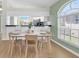 Bright dining area adjacent to the kitchen with a large window providing ample natural light at 11700 Leda Ln, New Port Richey, FL 34654