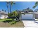 Charming single-story home featuring a well-manicured lawn and a two-car garage at 11700 Leda Ln, New Port Richey, FL 34654