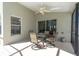 Enclosed patio with dining set and ceiling fan, perfect for outdoor relaxation at 11700 Leda Ln, New Port Richey, FL 34654