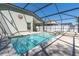 Refreshing pool and spa within a screened enclosure, with a sun decoration at 11700 Leda Ln, New Port Richey, FL 34654
