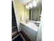 Bathroom featuring a white vanity and a shower with glass doors at 12027 Hoosier Ct # 104, Hudson, FL 34667