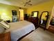 Bright bedroom with wood floors, dresser, and a ceiling fan at 12027 Hoosier Ct # 104, Hudson, FL 34667