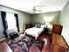 Traditional bedroom with hardwood floors, area rug, ceiling fan, and natural light from the window at 12027 Hoosier Ct # 104, Hudson, FL 34667
