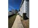 The side of a building featuring a well-kept walkway and neat landscaping at 12027 Hoosier Ct # 104, Hudson, FL 34667