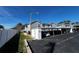 The exterior showcases covered parking spots and building facade under a clear blue sky at 12027 Hoosier Ct # 104, Hudson, FL 34667