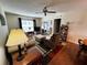 An inviting living room with hardwood floors, a ceiling fan and an open layout at 12027 Hoosier Ct # 104, Hudson, FL 34667