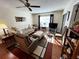 A comfy living room featuring hardwood floors, neutral furniture, and natural light at 12027 Hoosier Ct # 104, Hudson, FL 34667