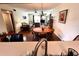 Open-concept living and dining area with wood floors and bright natural light at 12027 Hoosier Ct # 104, Hudson, FL 34667